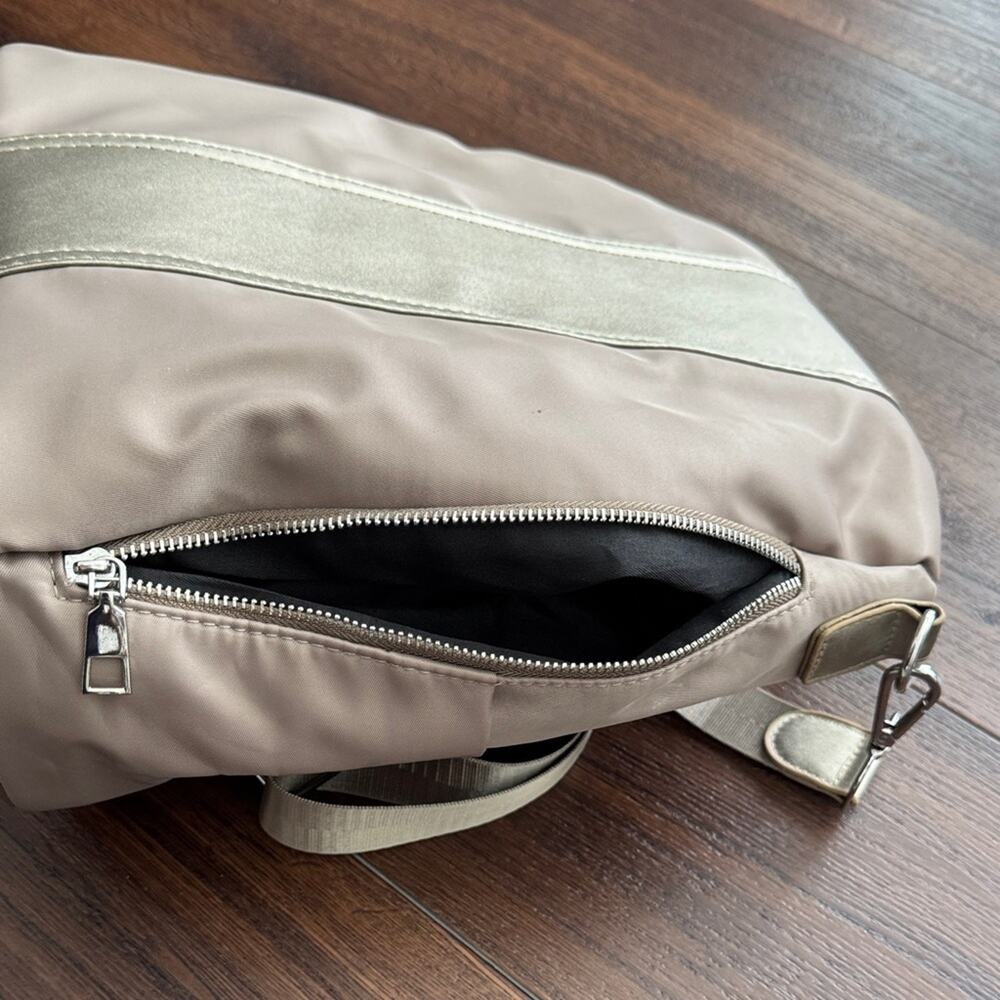 Neutral Taupe Woman’s Backpack with Metallic Accent and many zipper pockets. - Picture 8 of 13